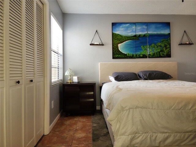 bedroom with dark tile patterned flooring