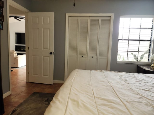 bedroom featuring tile patterned floors and a closet