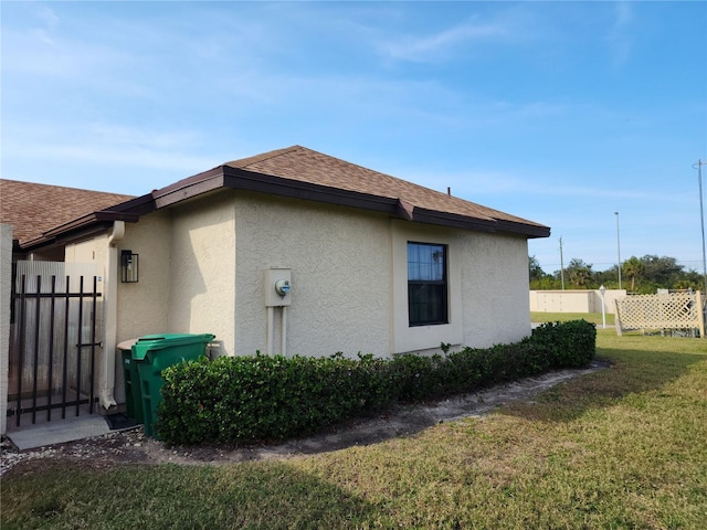 view of property exterior with a lawn