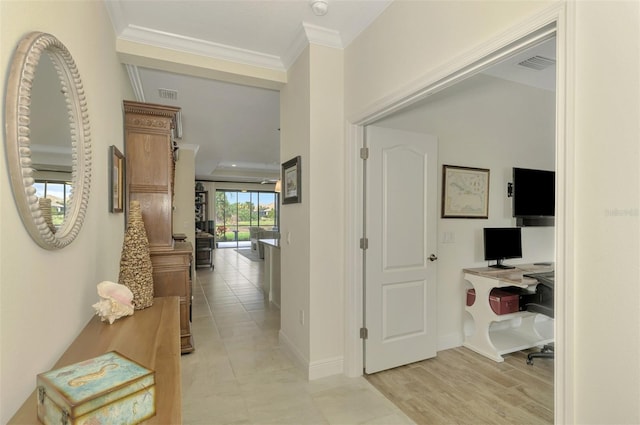 hallway with crown molding and light hardwood / wood-style flooring