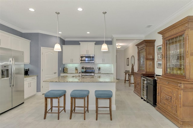 kitchen with white cabinets, pendant lighting, and appliances with stainless steel finishes