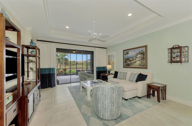 tiled living room featuring ceiling fan, crown molding, and a tray ceiling