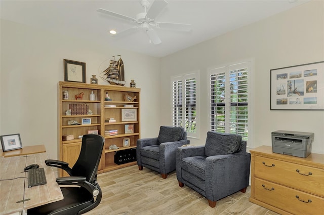 office area with ceiling fan and light hardwood / wood-style flooring