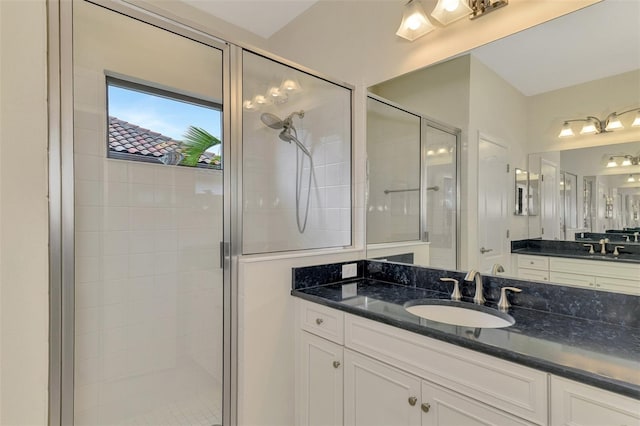 bathroom with an enclosed shower and vanity