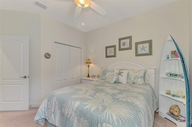 bedroom featuring light carpet, a closet, and ceiling fan