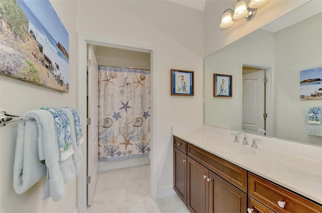 bathroom with walk in shower and vanity