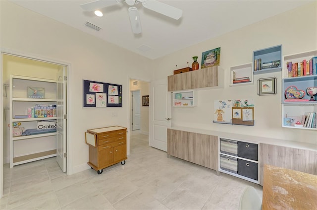 interior space with ceiling fan