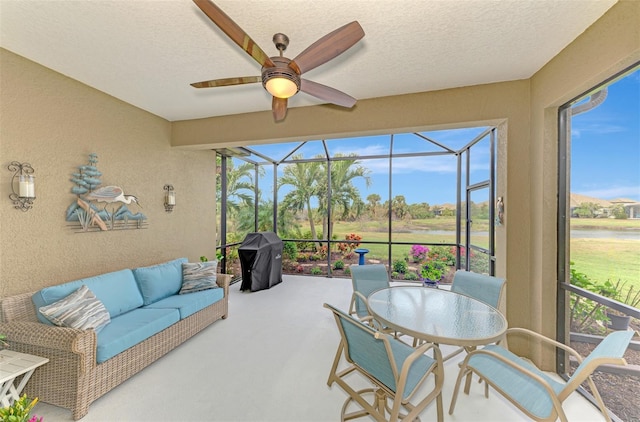 sunroom / solarium featuring ceiling fan and a healthy amount of sunlight