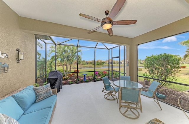 sunroom / solarium featuring ceiling fan and a healthy amount of sunlight