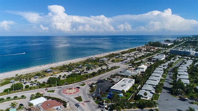 birds eye view of property featuring a water view and a beach view