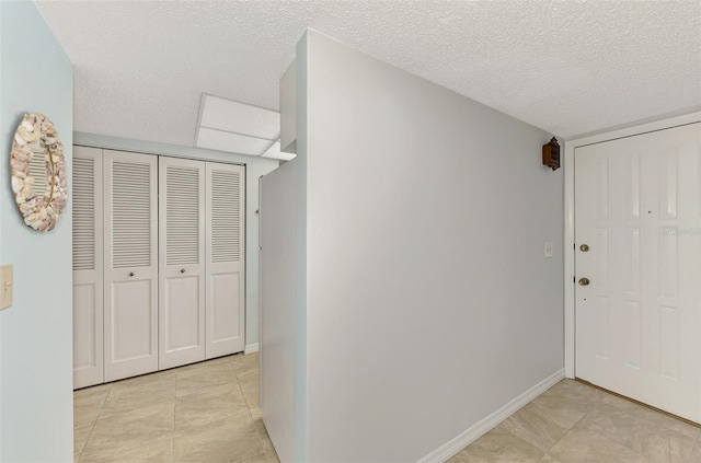 corridor featuring a textured ceiling