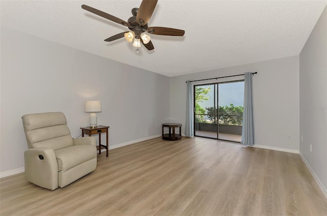 unfurnished room with ceiling fan, light hardwood / wood-style floors, and a textured ceiling