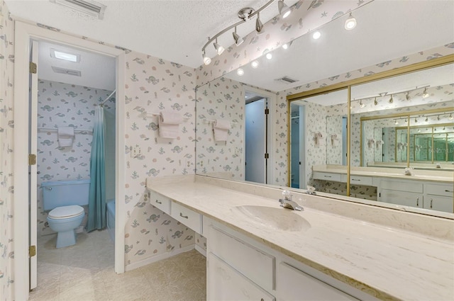 bathroom with vanity, a textured ceiling, toilet, and a shower with shower curtain