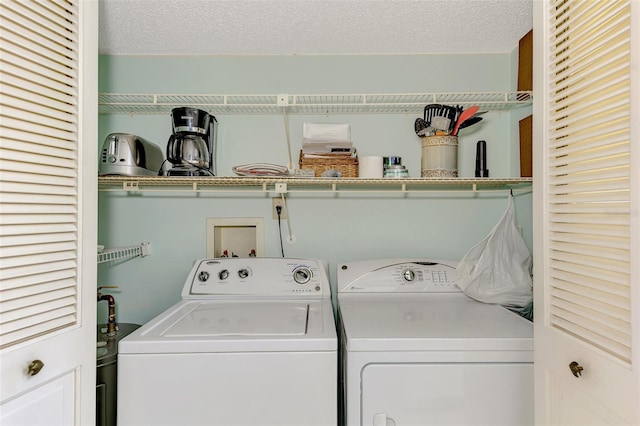 washroom with independent washer and dryer and a textured ceiling