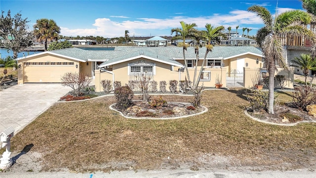 ranch-style home with a garage and a front lawn