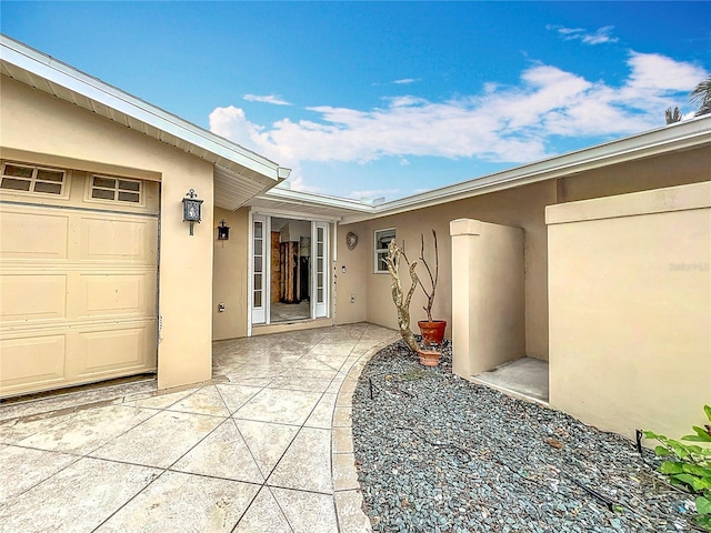 doorway to property with a garage