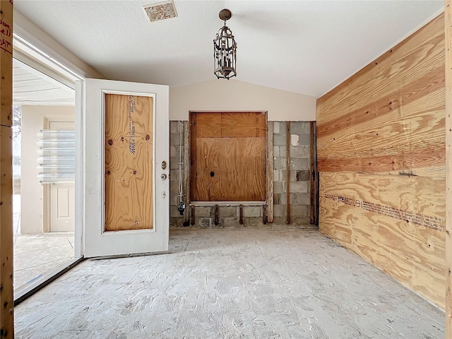 spare room with lofted ceiling