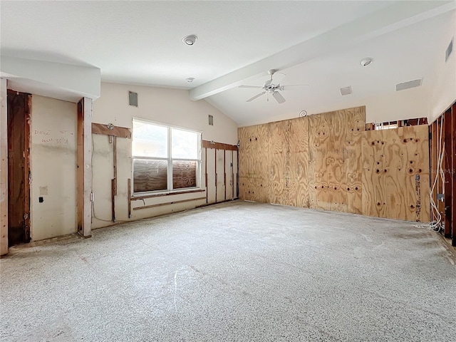 spare room with ceiling fan and vaulted ceiling with beams