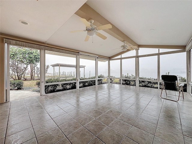 unfurnished sunroom featuring vaulted ceiling with beams