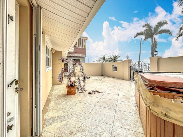 view of patio / terrace with a hot tub