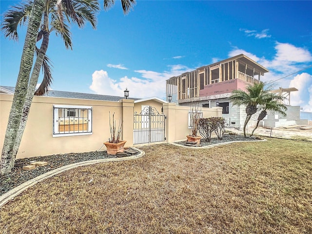 view of front of home featuring a front lawn and a sunroom