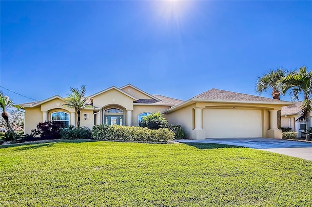 ranch-style house featuring a garage and a front lawn