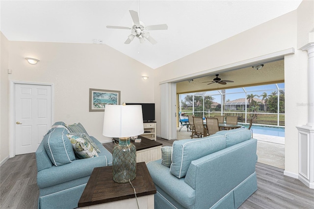 living room featuring vaulted ceiling, ceiling fan, and hardwood / wood-style floors