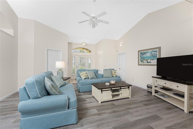 living room with lofted ceiling, hardwood / wood-style flooring, and ceiling fan