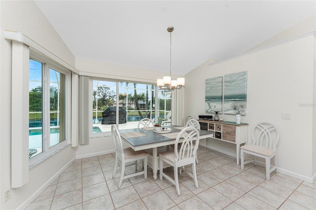 dining room featuring vaulted ceiling, light tile patterned floors, and a notable chandelier