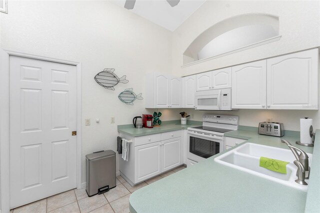 kitchen with sink, white appliances, and white cabinets