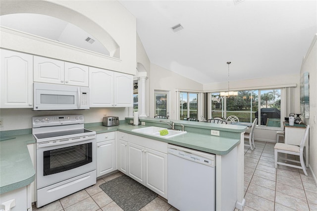 kitchen with white appliances, kitchen peninsula, sink, and white cabinets