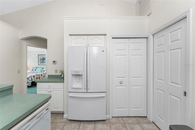 kitchen with white cabinetry, light tile patterned floors, and white appliances