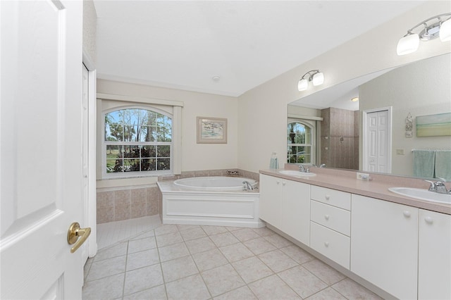 bathroom featuring tile patterned floors, vanity, and a tub