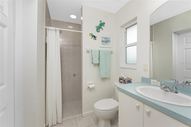 bathroom with vanity, toilet, curtained shower, and tile patterned flooring