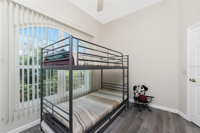 bedroom with lofted ceiling, dark wood-type flooring, and ceiling fan