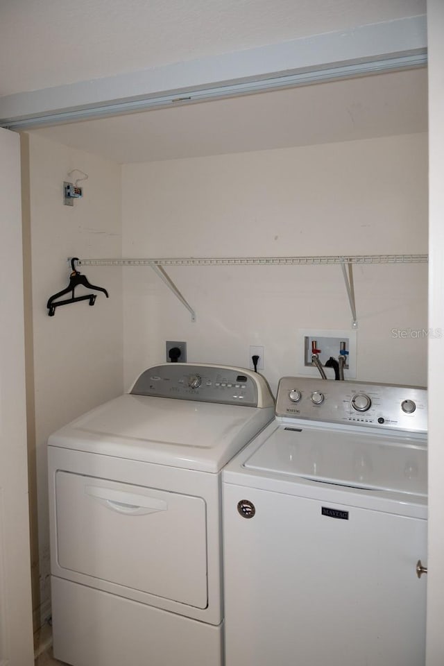 laundry room featuring washing machine and clothes dryer