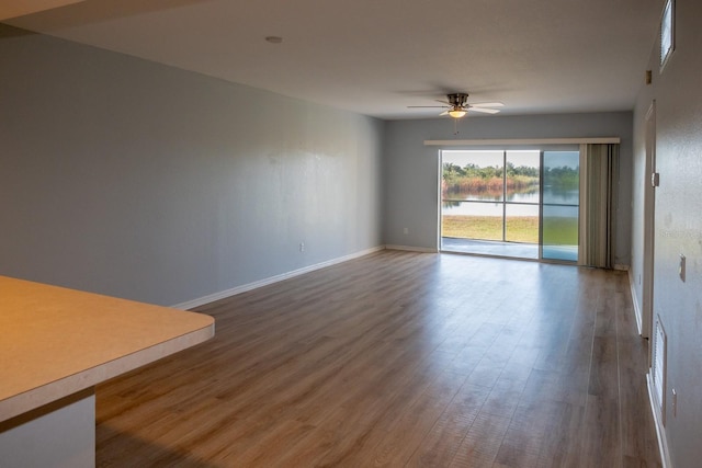 empty room with wood-type flooring and ceiling fan