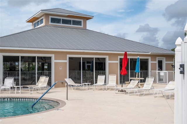 rear view of house with a patio and a community pool