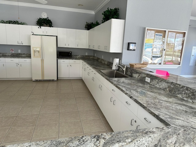 kitchen featuring light tile patterned flooring, sink, white cabinetry, crown molding, and white fridge with ice dispenser