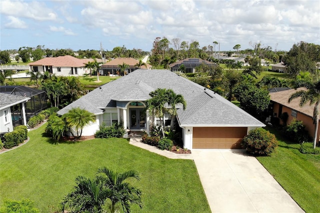 view of front of property with a garage and a front lawn