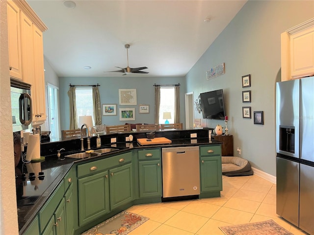 kitchen featuring sink, white cabinetry, light tile patterned floors, appliances with stainless steel finishes, and a healthy amount of sunlight