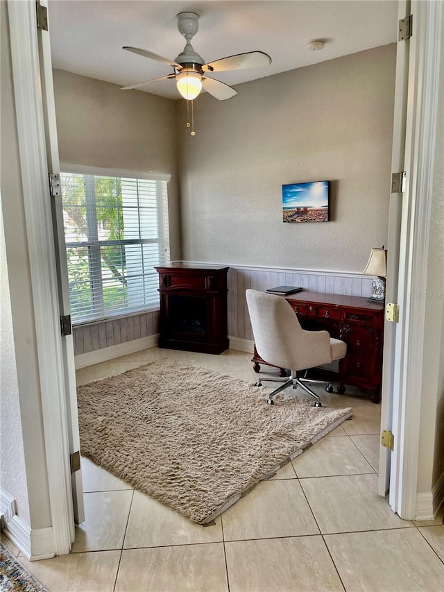 tiled office space featuring ceiling fan