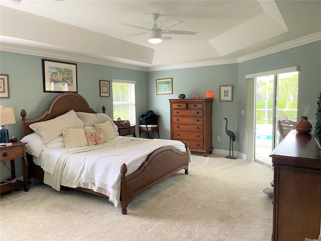 bedroom featuring light colored carpet, access to outside, ornamental molding, a tray ceiling, and ceiling fan