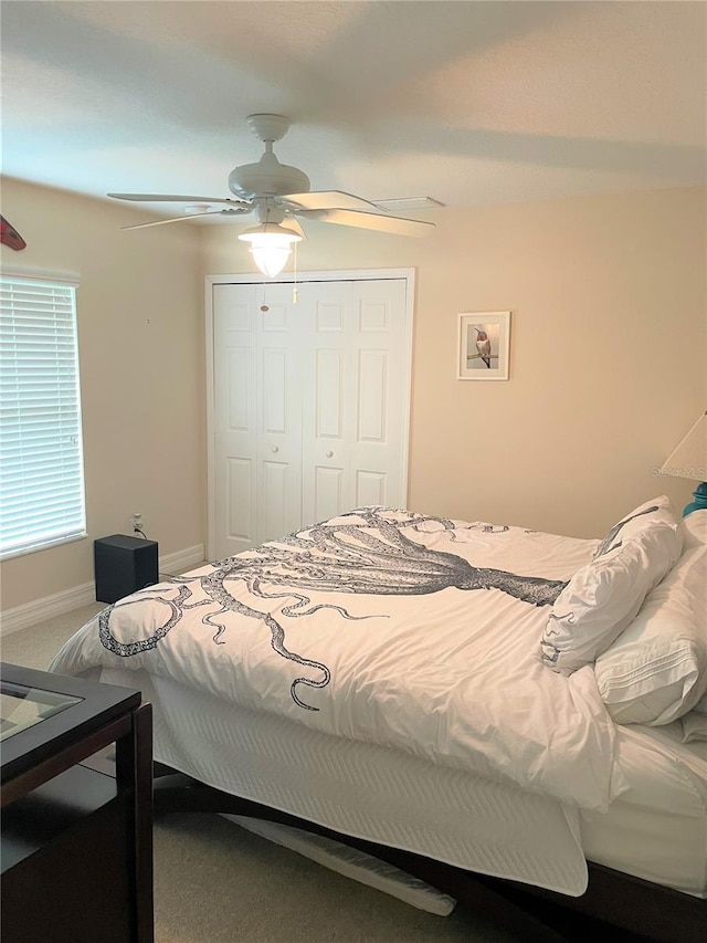 bedroom featuring a closet, ceiling fan, and carpet