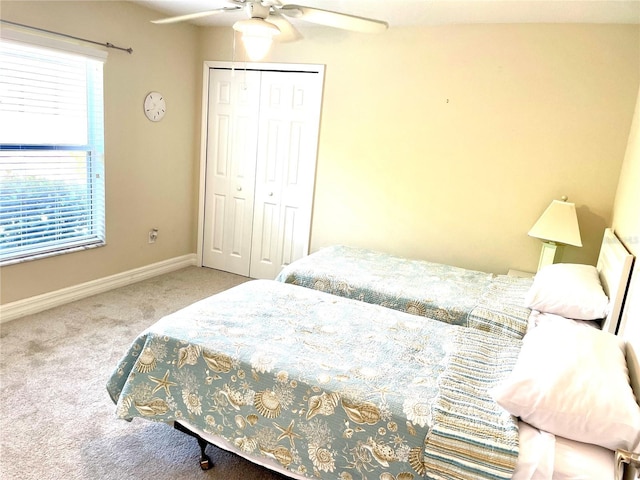 bedroom with carpet floors, ceiling fan, and a closet