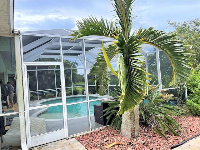 view of swimming pool with glass enclosure