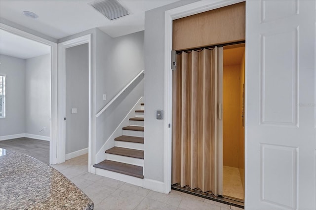 stairs with tile patterned floors