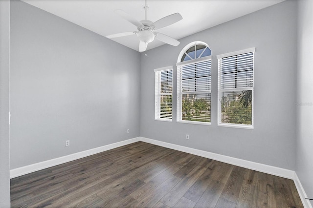 unfurnished room with dark hardwood / wood-style flooring and ceiling fan