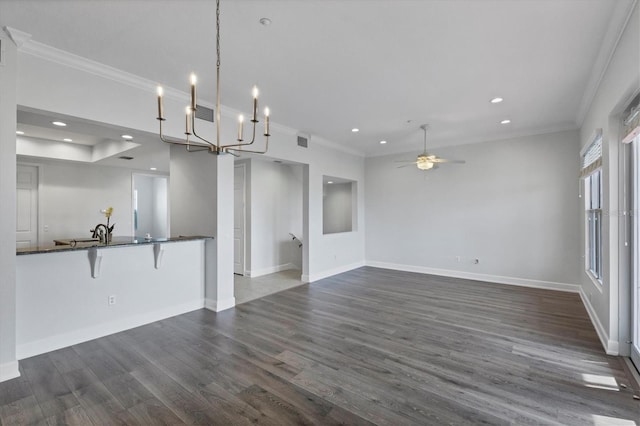 unfurnished living room featuring ornamental molding, dark hardwood / wood-style floors, sink, and ceiling fan