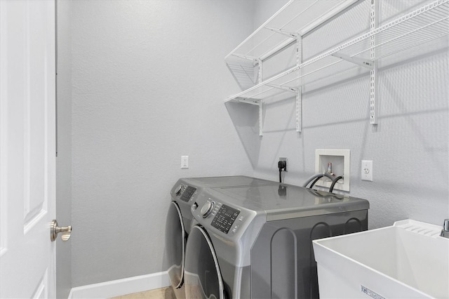 laundry area with sink and washer and dryer